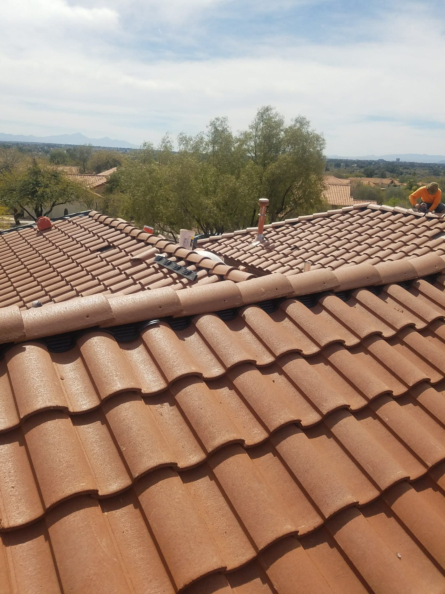 Mid-install concrete S-tile re-roof in Madera Highlands, Sahuarita with Catalinas in background